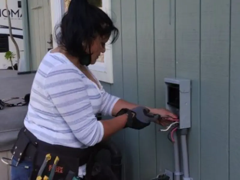 Licensed electrician wiring an exterior subpanel in Georgetown